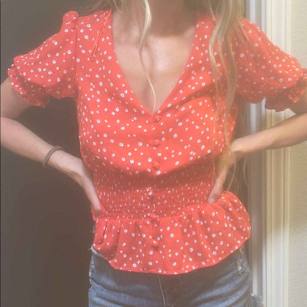 Red blouse with white tiny flowers